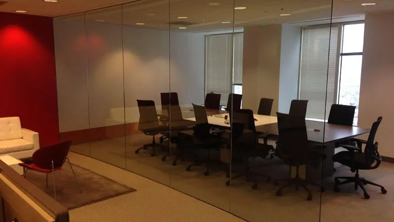 Interior office glazing before any privacy film — the whole room visible from the corridor.